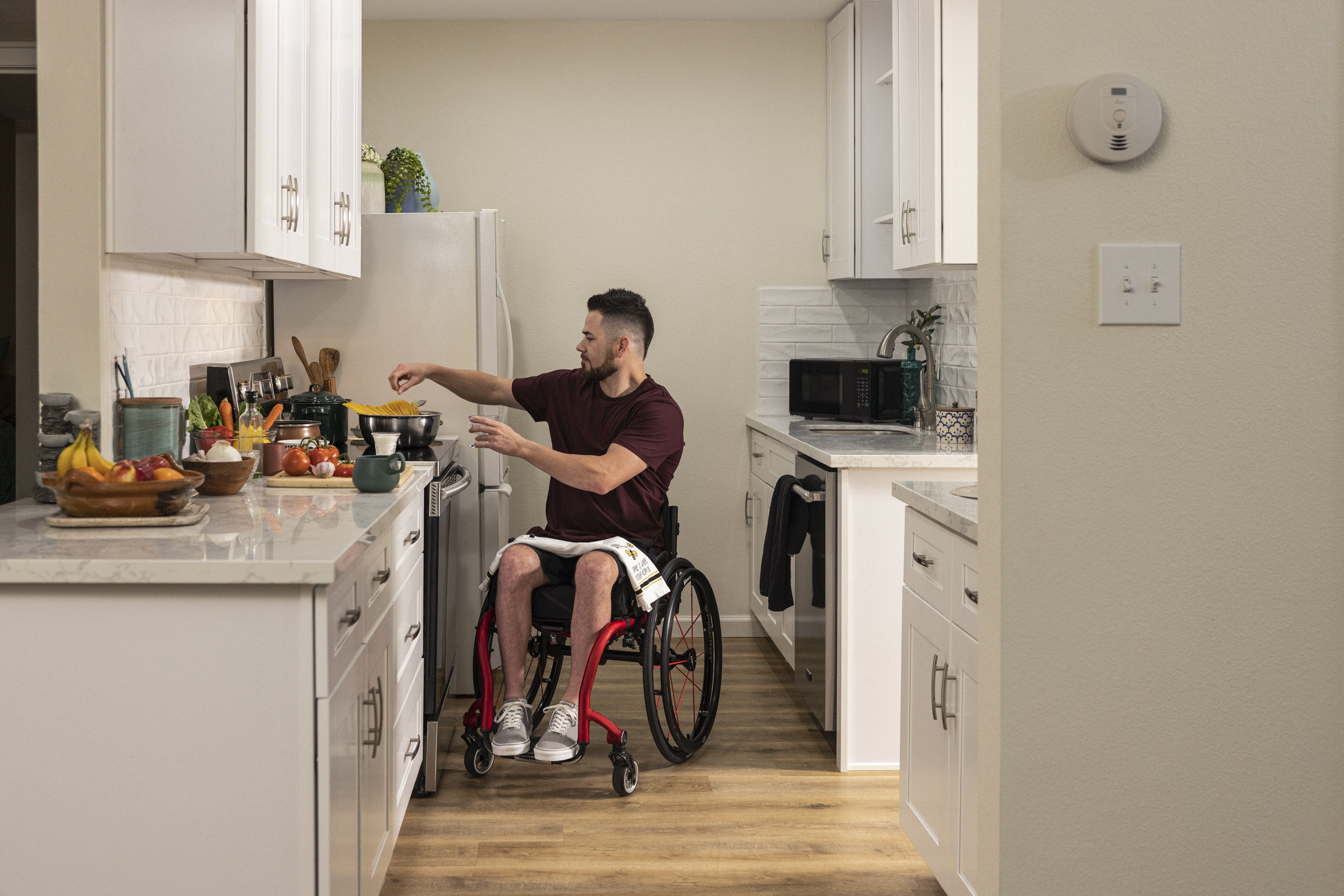 Fire Safety - A person who uses a wheelchair cooking safely in their kitchen.