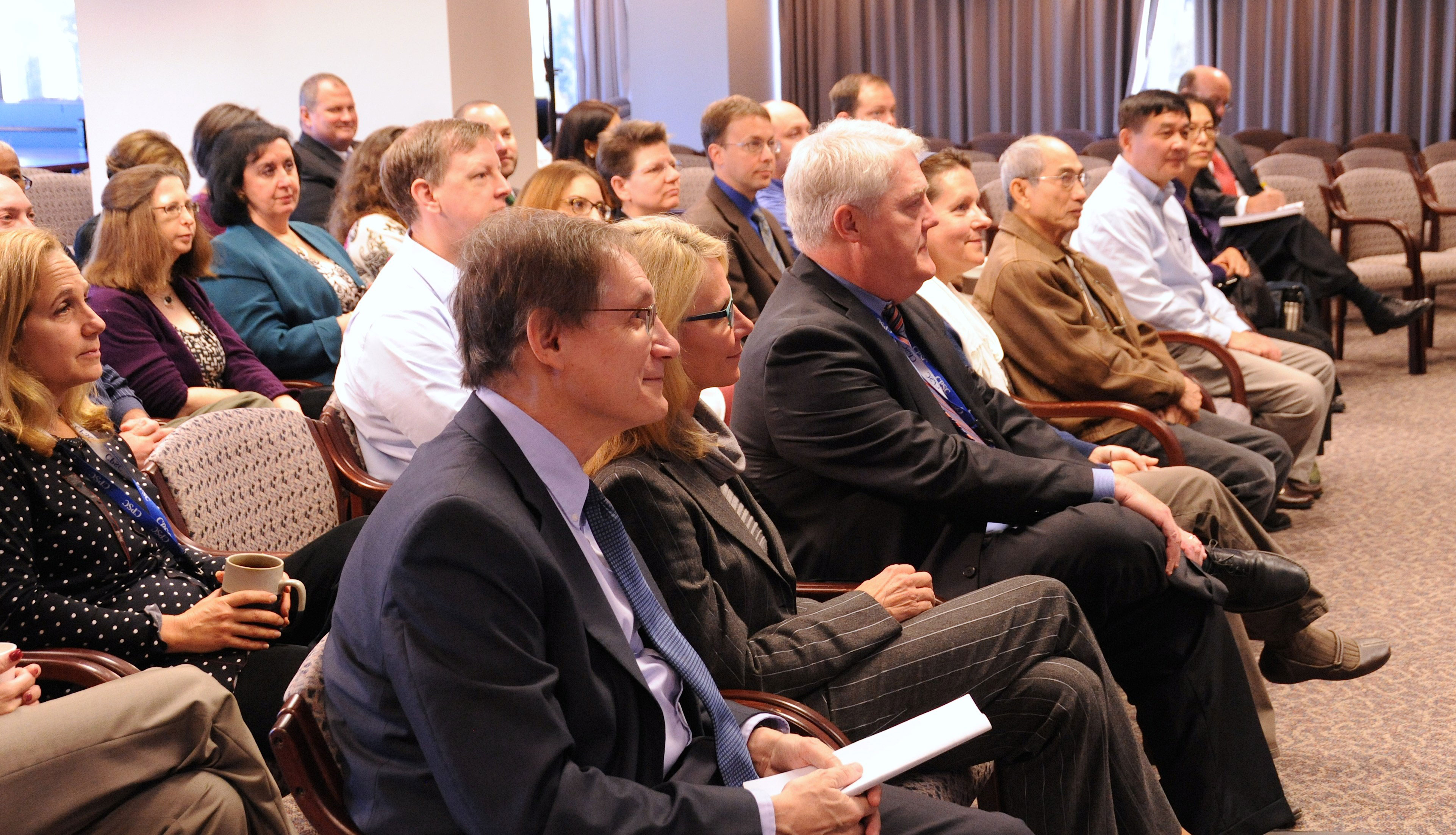 Commissioner Adler, Commissioner Robinson and other members of the audience listen to the winners present their apps.