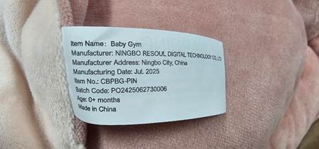 "Baby Gym" and "Item No.: CBPBG-PIN" are printed on a label stitched to the product on the edge of the mat at the bottom