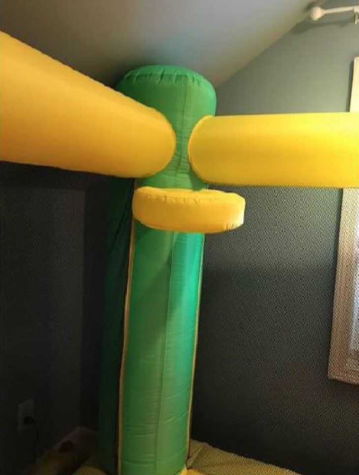 The yellow hoop attached to the green pole inside My Bouncer Little Castle Bounce House  