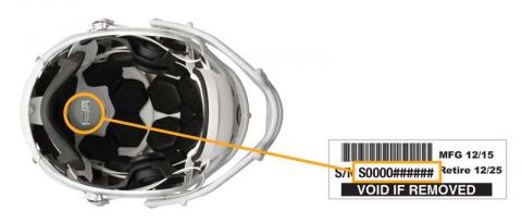 The serial number is printed on a white sticker inside the top of the helmet.
