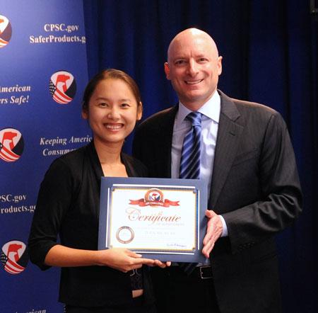 Xian Ke receives her certificate from Chairman Kaye. Xian won in the “Most Innovative” category for her Total Recall 101 app.