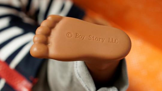 Boy Story LLC stamped on the left foot of each doll