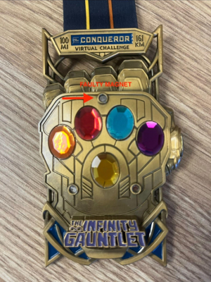 Recalled Avengers Infinity Gauntlet Medal showing faulty magnet 