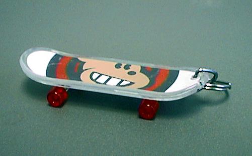 Recalled miniature skateboard keychain attached to Z.Z. Jamboarder teddy bears