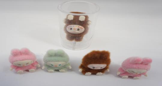 Mini versions of lookalike Labubu dolls that fit entirely within the small parts cylinder