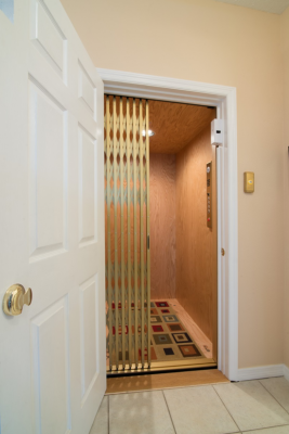The door to the elevator generally matches all other doors in the home. The elevator gate may be open metal lattice or a solid folded sliding door.
