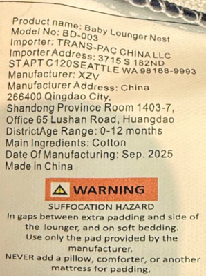 The model number is printed on a label stitched on the inside of the baby lounger’s cover