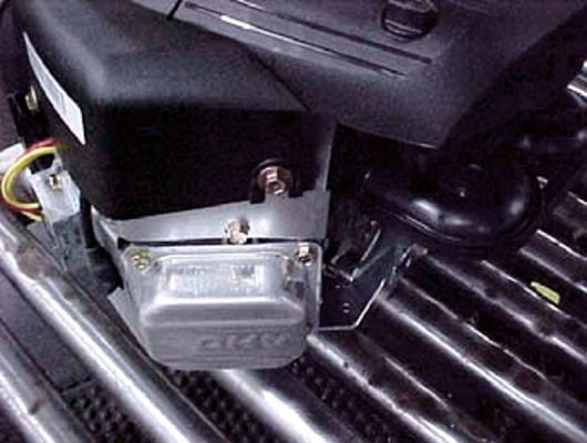 The valve cover is located at the front of the engine near the oil dipstick
