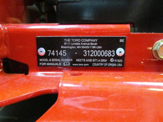 Model and serial numbers located at the front of the mower, below the seat, on the right-hand side.