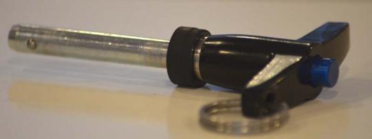 Recalled retaining pin with blue push-button release