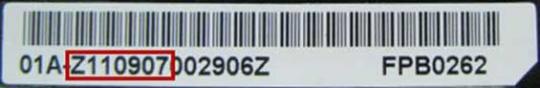 The serial number is located on the white battery label