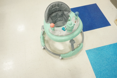 Recalled Zeno infant walker with gray frame, gray seat with “Babywalker” stitching, teal tray and toy attachments