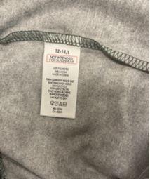 Sewn-in, side-seam label states size, “Not Intended for Sleepwear,” “RN 15741,” the fiber content, “Made in China,” and washing instructions 