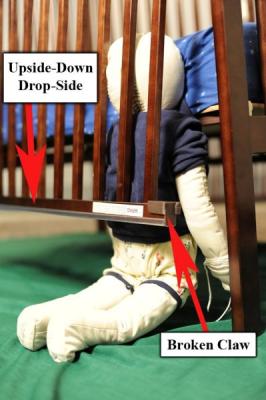 Recalled Crib showing entrapment hazard with upside-down drop-side and broken claw