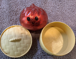Recalled Squishy Dumpling and tan container 