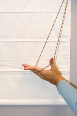Picture of recalled insulated black-out roller shades and insulated Roman shades