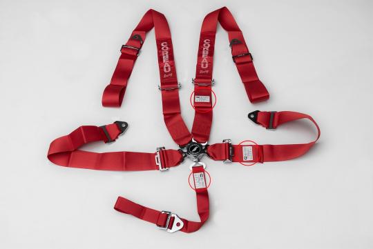 Red 5-Point Camlock Harness Belt with locations of label containing manufacture date highlighted. 