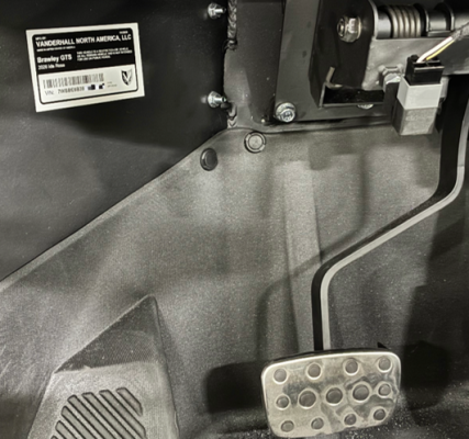 The VIN is visible underneath the driver-side dashboard, left of the foot pedals