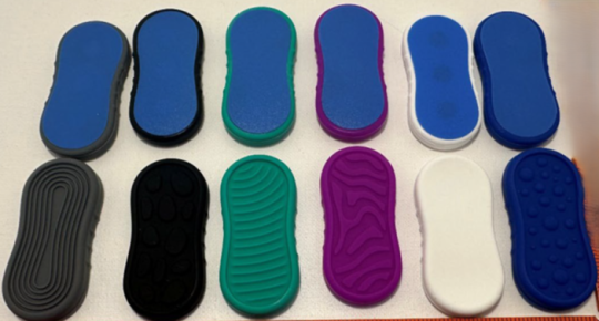 Recalled BUSOHA Magnetic Fidget Slider Toys - one side is blue and the opposite side is in different colors and textures