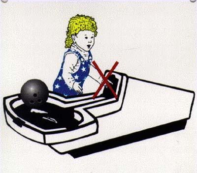 Child putting hand in bowling ball return