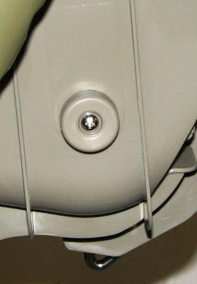 Image of recalled highchair cap and screw hazard