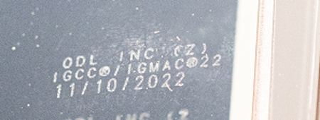 Example of Manufacturing Date Code on recalled doorglass inserts (Illuminated With Flashlight, Cell Phone, etc.)