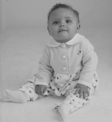 Baby wearing recalled Peek-A-Babe garments (one-piece coveralls)