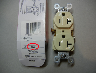 Front view of recalled receptacle with packaging and model number circled in red