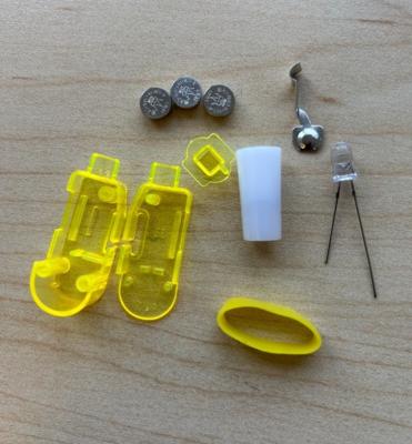 The recalled Syera Space Astronaut finger lights have three internal button cell batteries that power astronaut projections