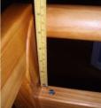 Recalled crib, incorrectly assembled, with a ruler showing a gap of about 5 inches