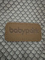 “babypark” is stitched on a brown fabric patch on the front of the carrier.