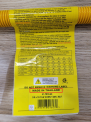 Close-up view of the yellow label on the recalled gas connector with “Made in Thailand” listed on label