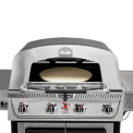 A close up of the pizza oven featured in the recalled grill, with the glass window open