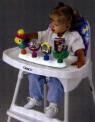 Girl in High Chair Playing with Activity Tray