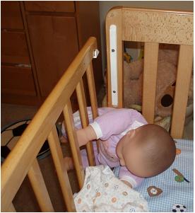 Picture of recalled crib with baby trapped